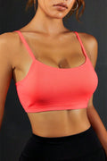 Coral backless sports cami with scoop front and thin straps.