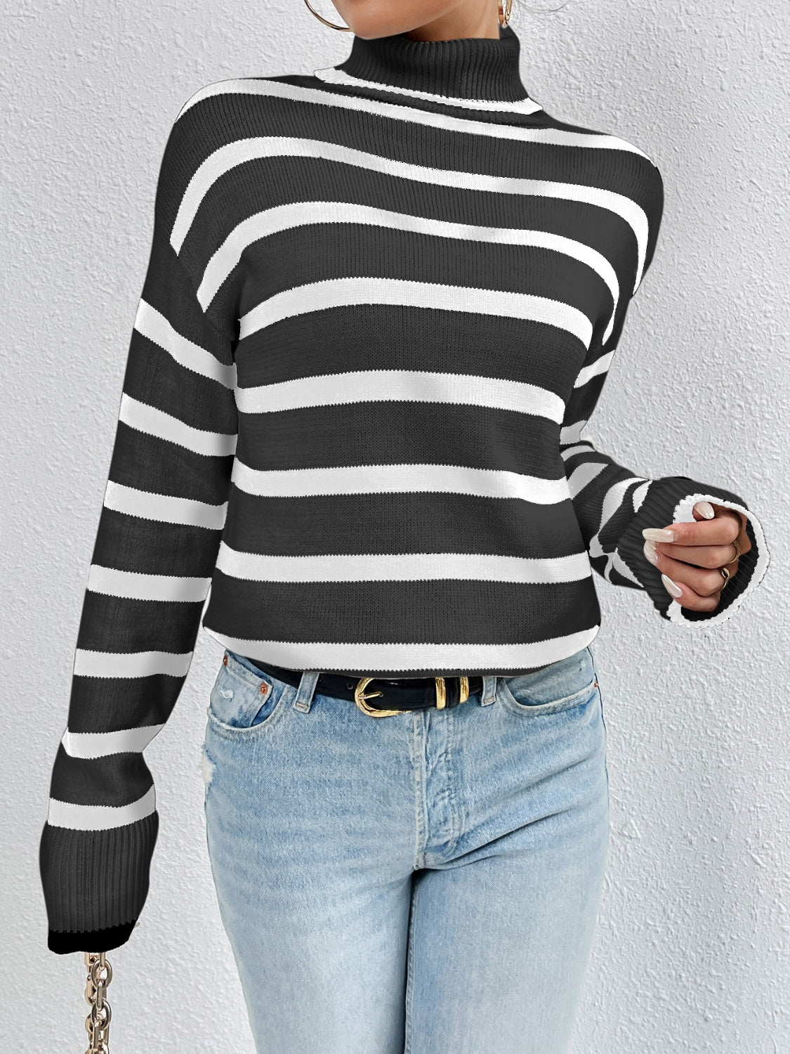 Black and white striped turtleneck sweater with ribbed cuffs and drop-shoulder
