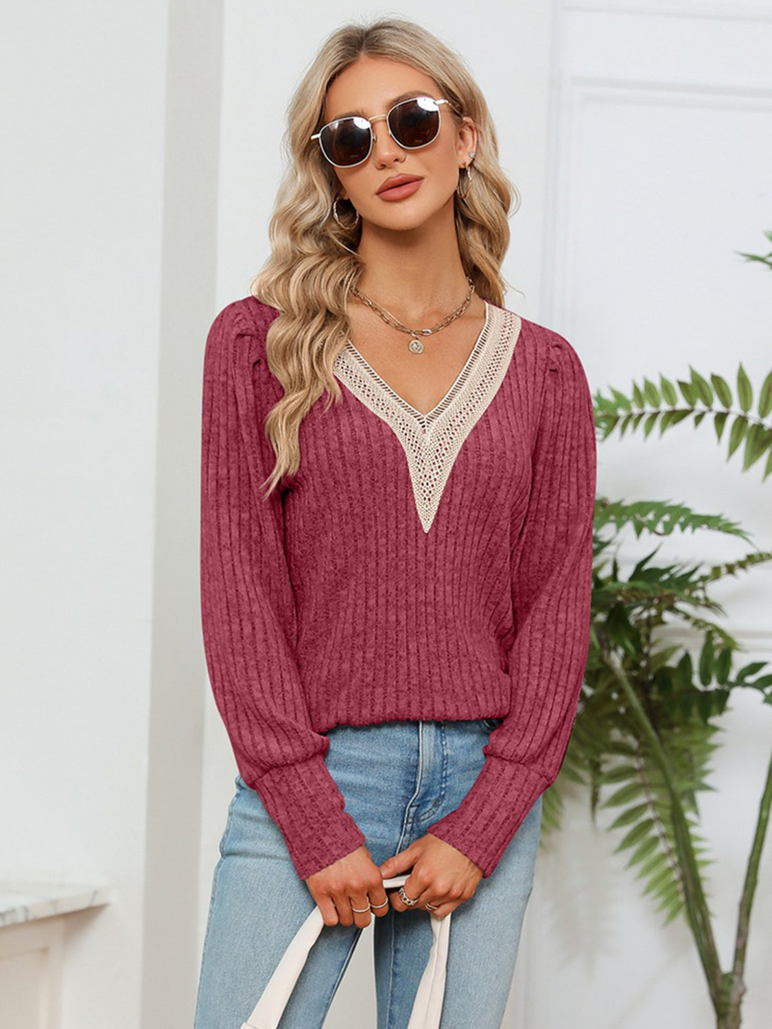 Brick red ribbed knit V-neck blouse with lace trim and long sleeves