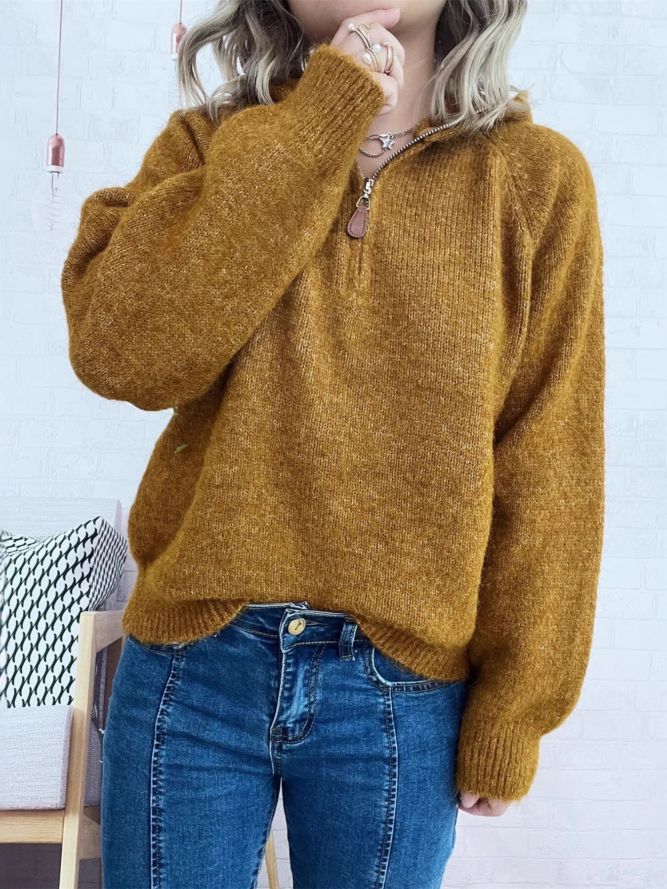Brown quarter-zip sweater with long sleeves, ribbed hem and half-zip placket