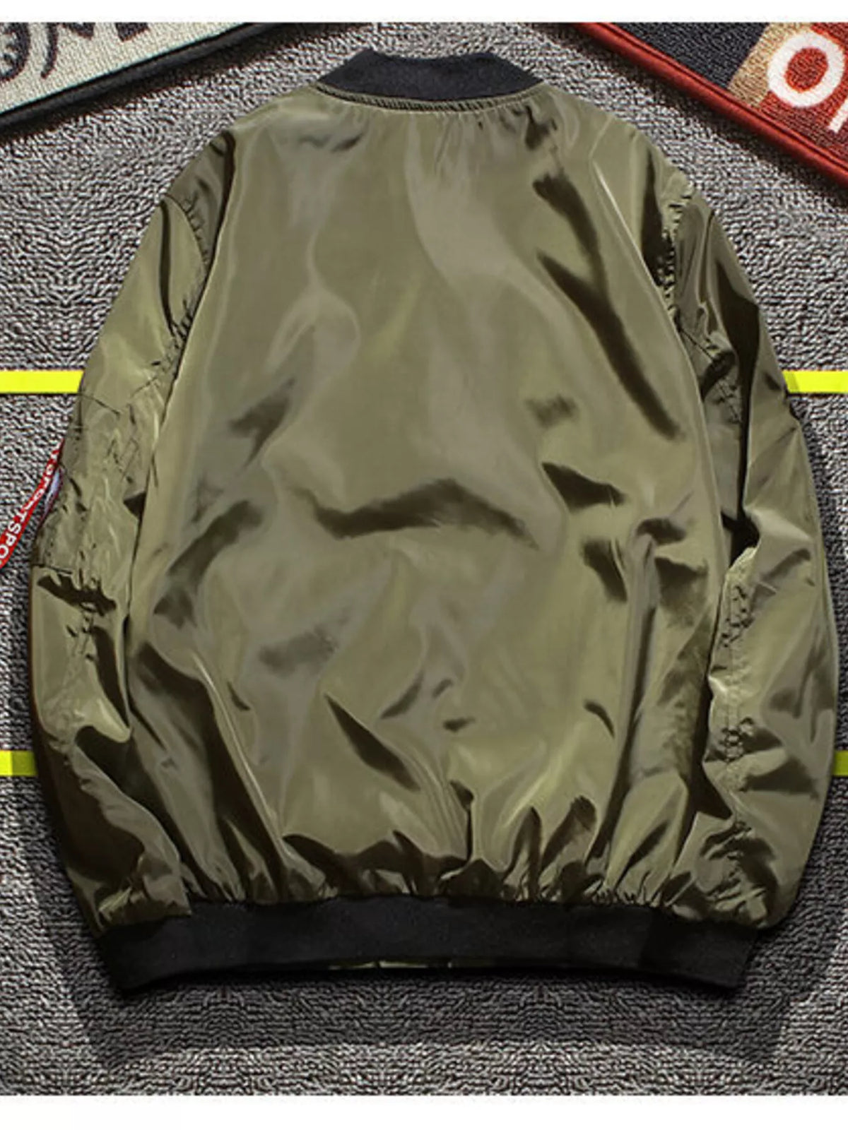 Olive green bomber jacket back view with ribbed hem and cuffs