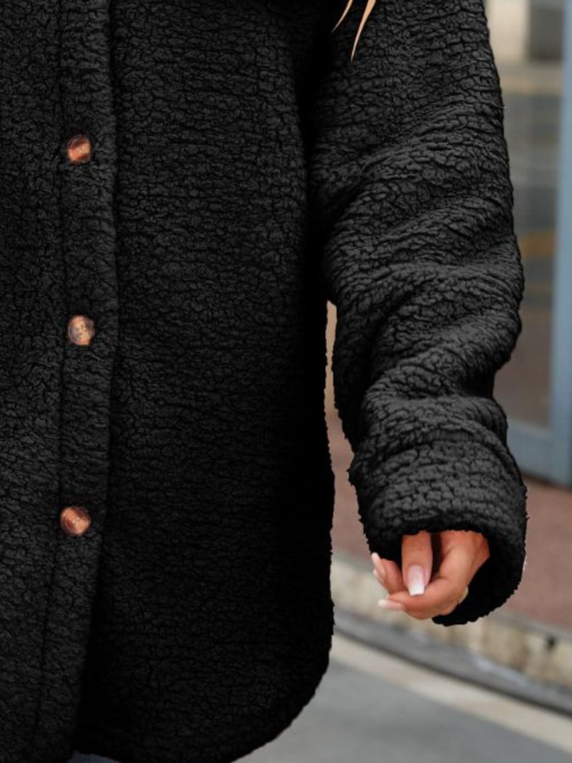 Black button-down coat with textured long sleeve and cuff