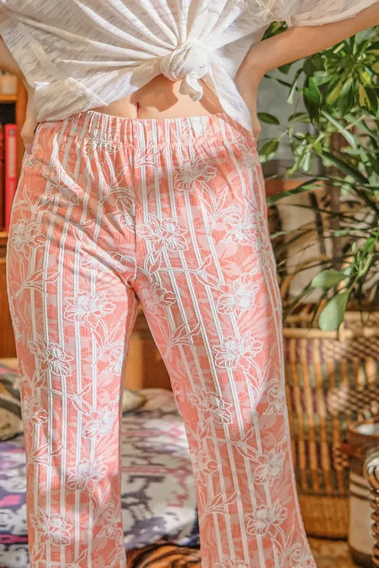 Orange patterned flare pants with elastic waist and wide flare legs