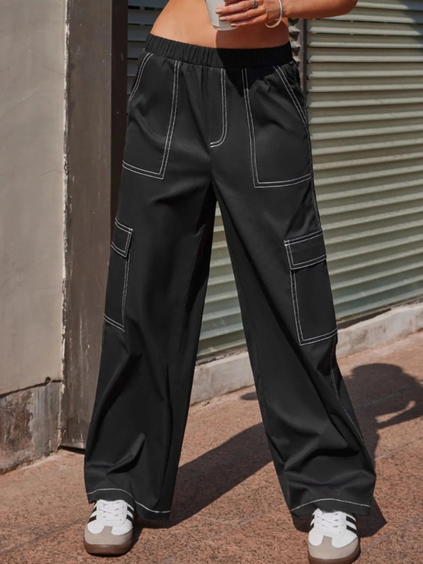 Black wide-leg cargo pants with contrast stitching and elastic waist pull-on style