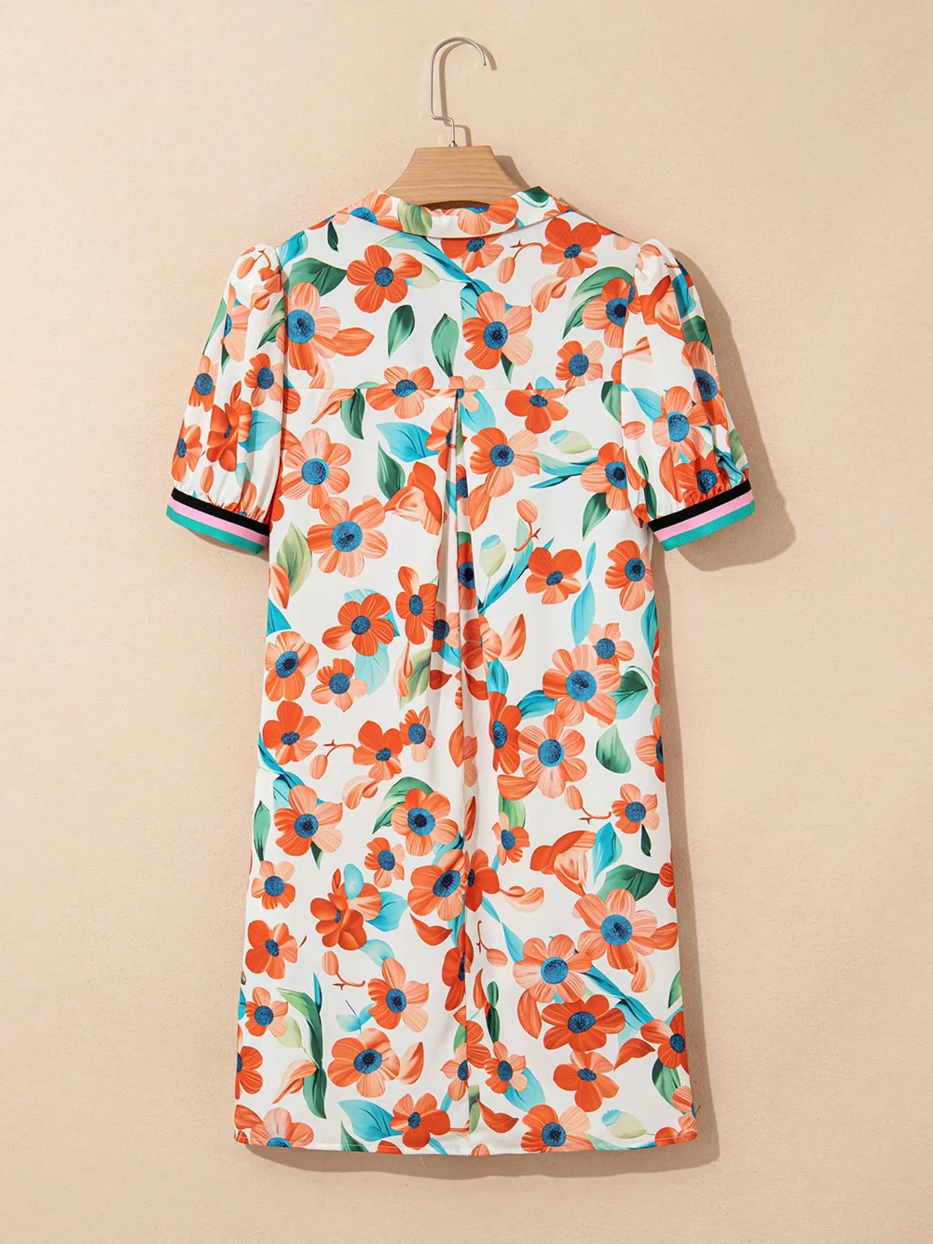 Trendsi floral mini dress; orange flowers with blue centers and green leaves; puff sleeves with striped cuffs.