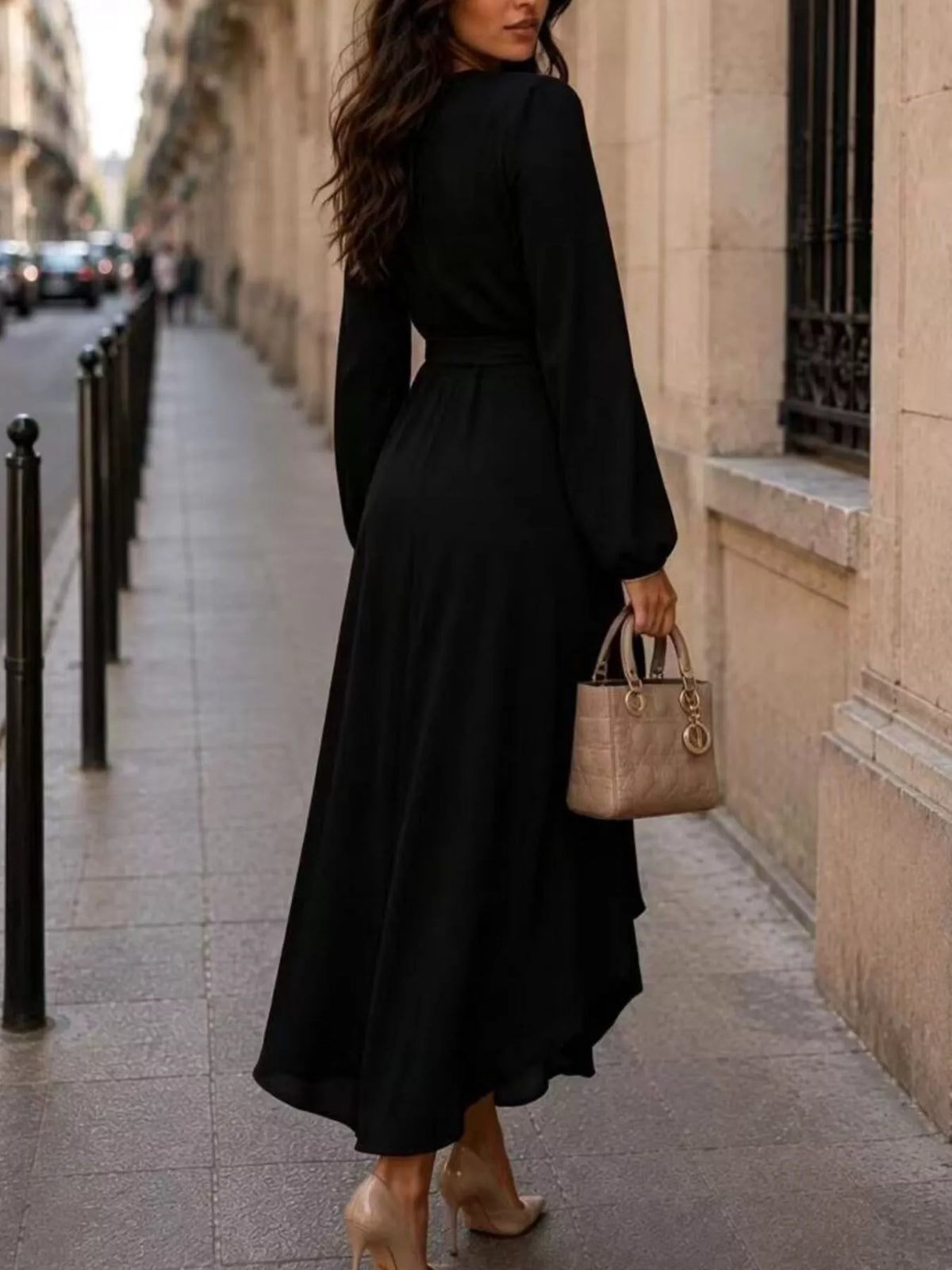Black long sleeve wrap dress with waist tie and flowing high-low asymmetric skirt