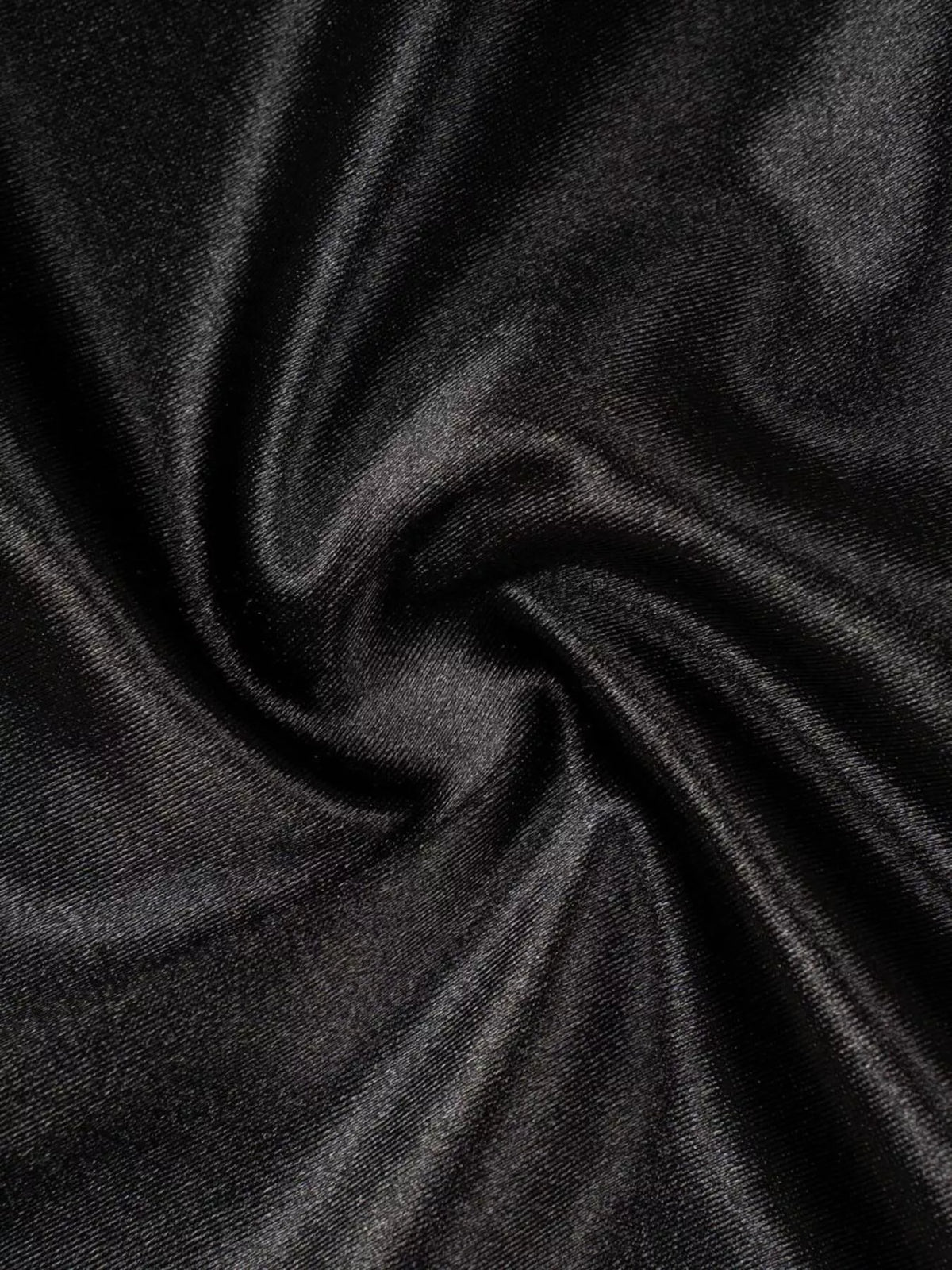 Black satin fabric close-up with glossy weave and soft folds