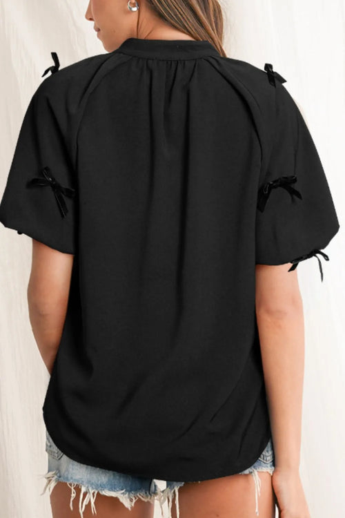 Black back view puff-sleeve blouse with bow ties at sleeve cuffs