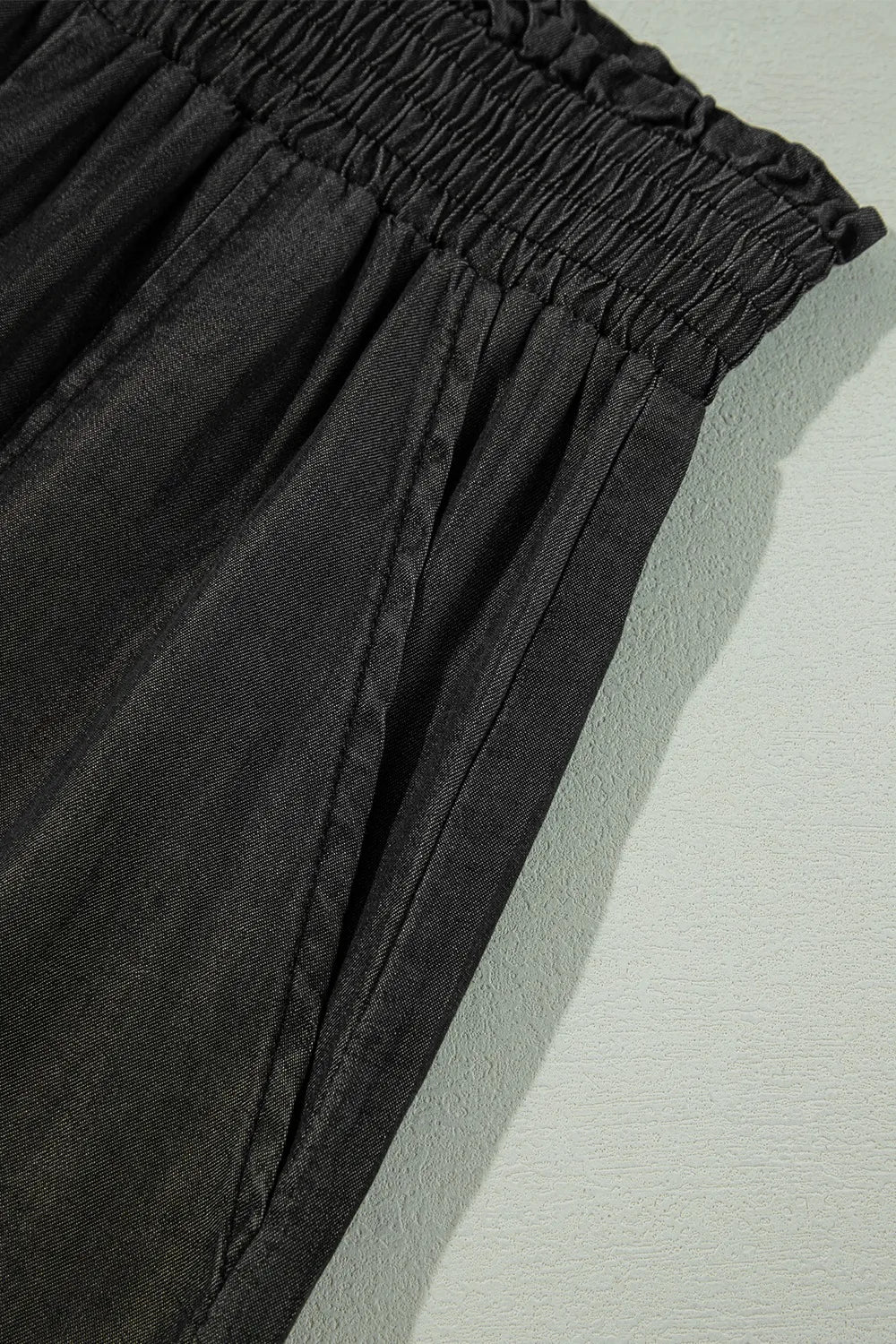 Black smocked high-waist waistband with ruffled trim
