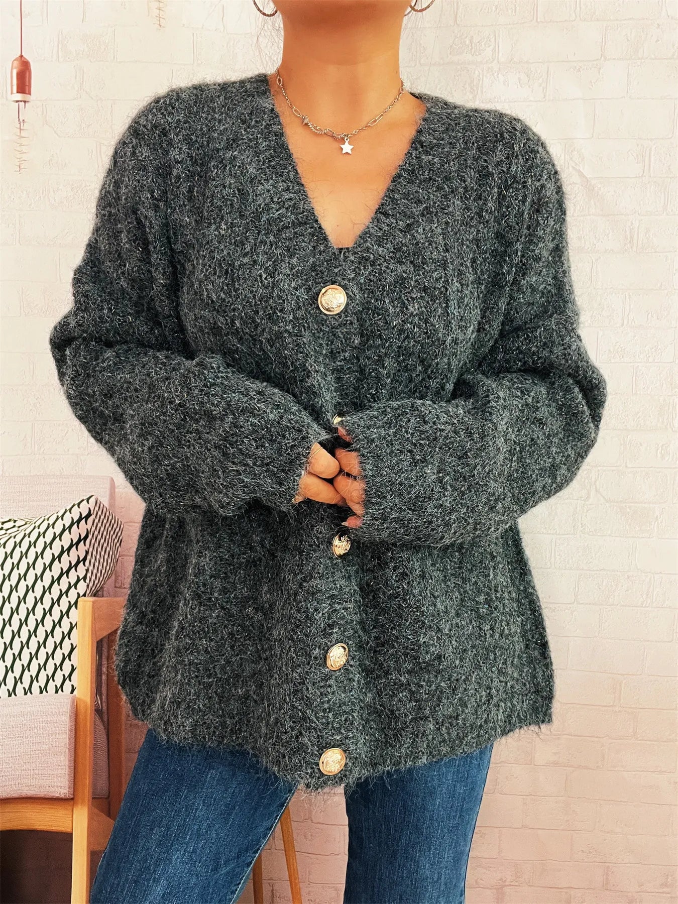 Dark gray knit cardigan with deep V-neck button front and long sleeves, round gold buttons
