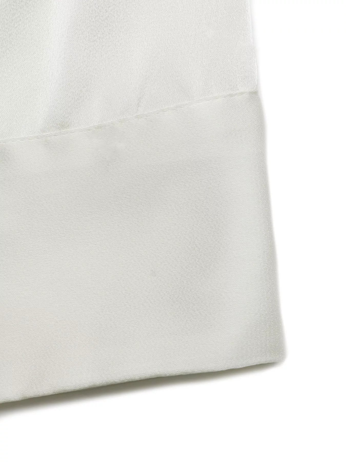 Cedar & Moore Halter Neck Satin Tank, white satin fabric close-up with diagonal hem seam