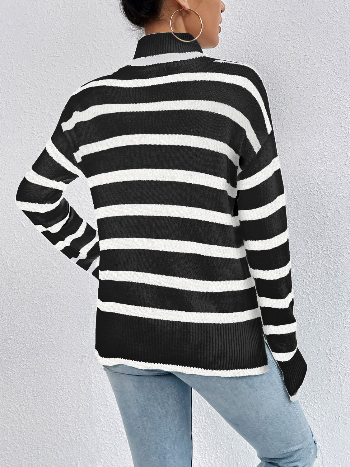 Black and white striped turtleneck sweater, back view with ribbed cuffs