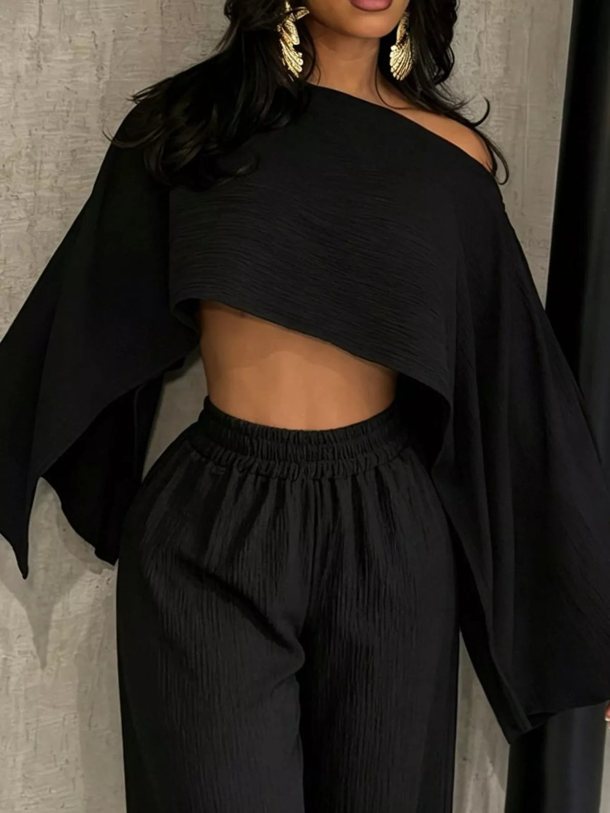 Black boat-neck crop top and wide-leg pants set, draped sleeve design and elastic waist