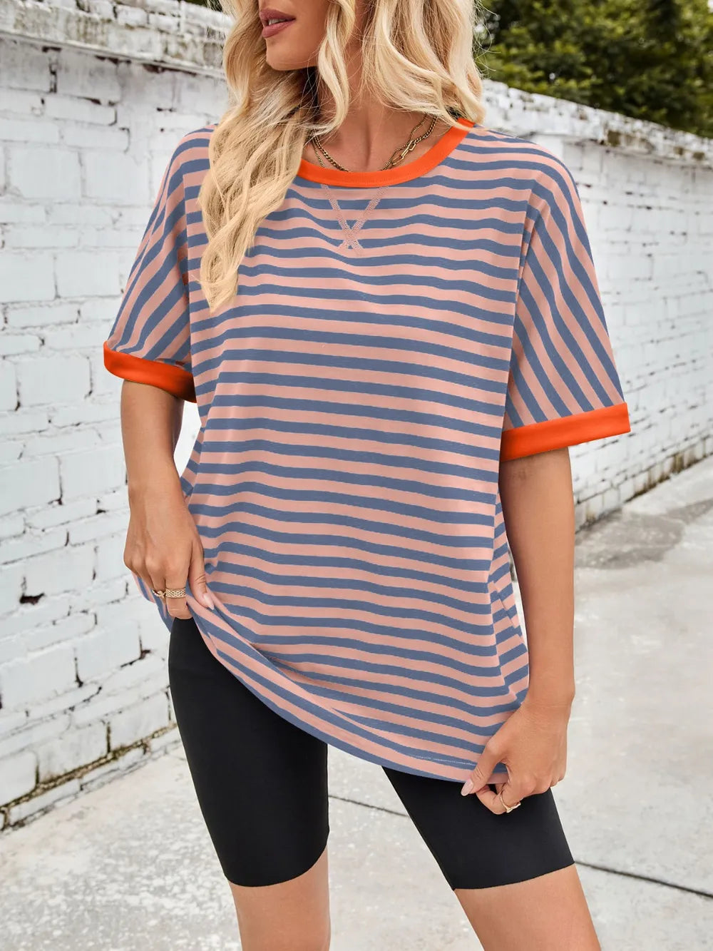 Striped round-neck half-sleeve T-shirt in blue with orange trim and curved hem