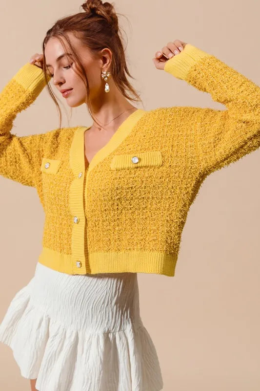 Mustard yellow knit button-front cardigan with patch pocket, V-neck and raised sleeves