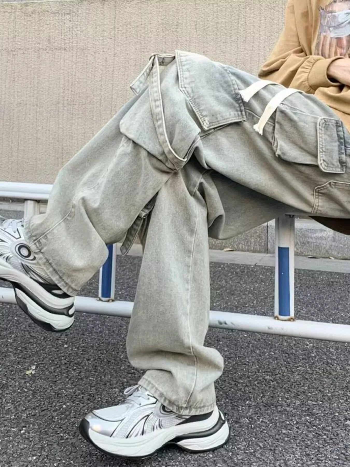Light gray wide-leg cargo jeans with drawstring waist and oversized cargo flap pockets