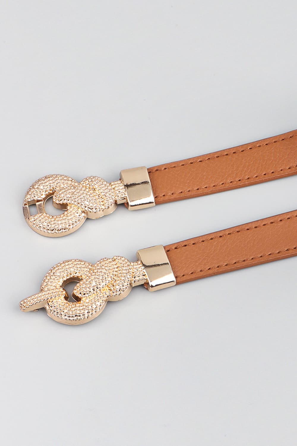 Caramel vegan leather belt with rhinestone-look oval buckle and metal clasp