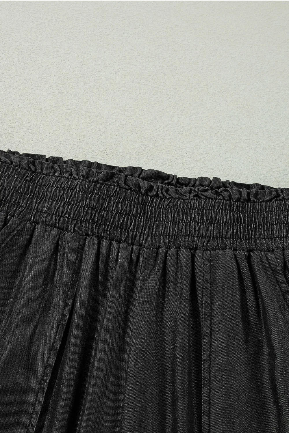Black smocked waistband with ruffled frill trim
