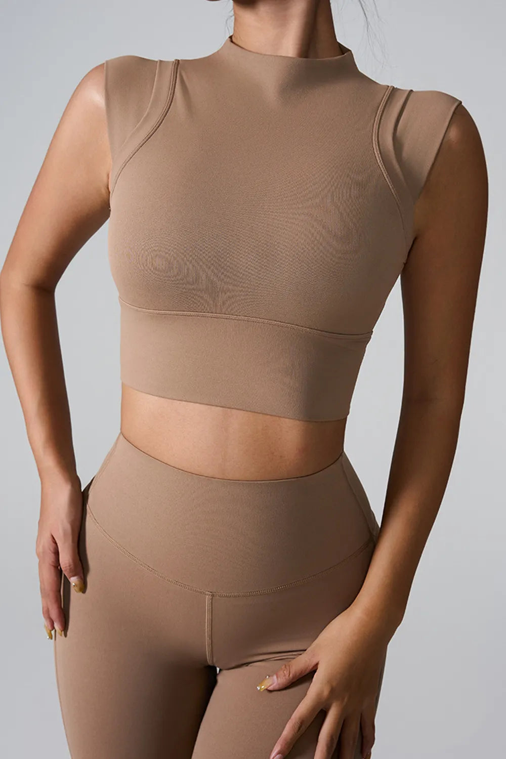 Camel mock neck active tank with cropped hem, sleeveless, fitted.
