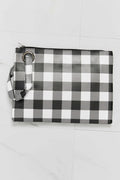 Black and white plaid wristlet pouch with zipper and wrist strap loop