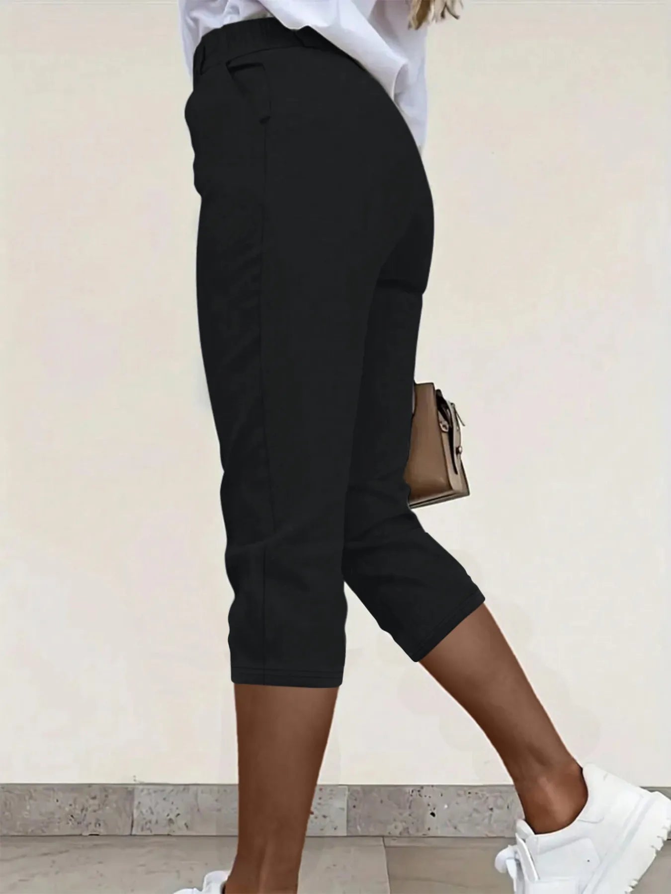 Black pleated capri pants with pockets and belt loops