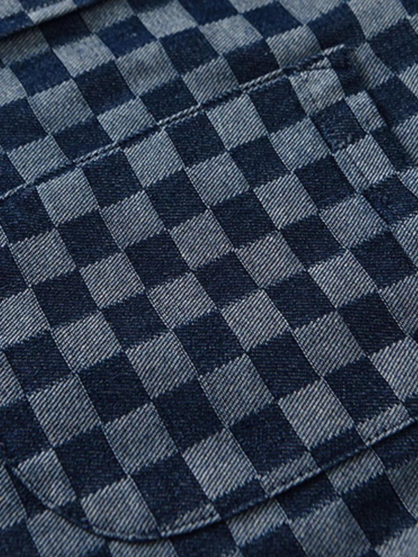 Close-up of blue checkered shirt fabric pattern with stitched seams