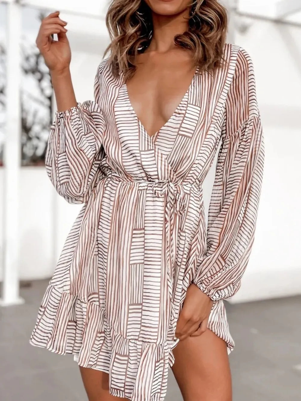 Camel-and-white striped surplice dress with V-neck, long puff sleeves, gathered waist