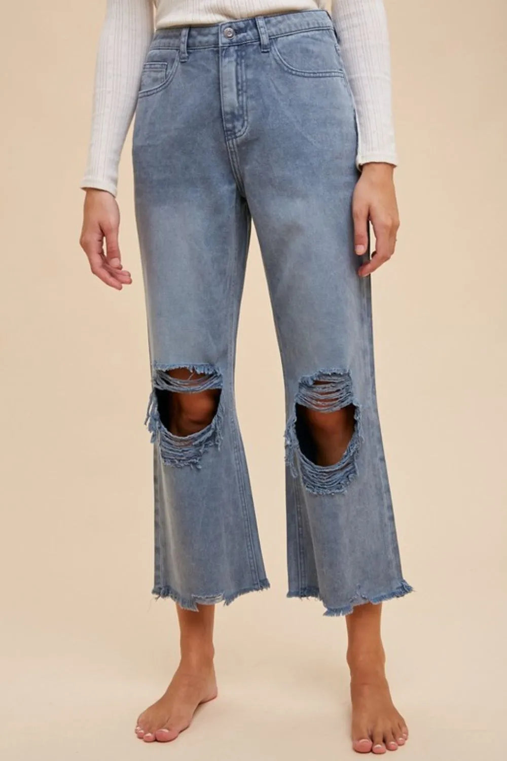 Distressed raw-hem jeans in dusty blue, cropped wide-leg with ripped knee hems