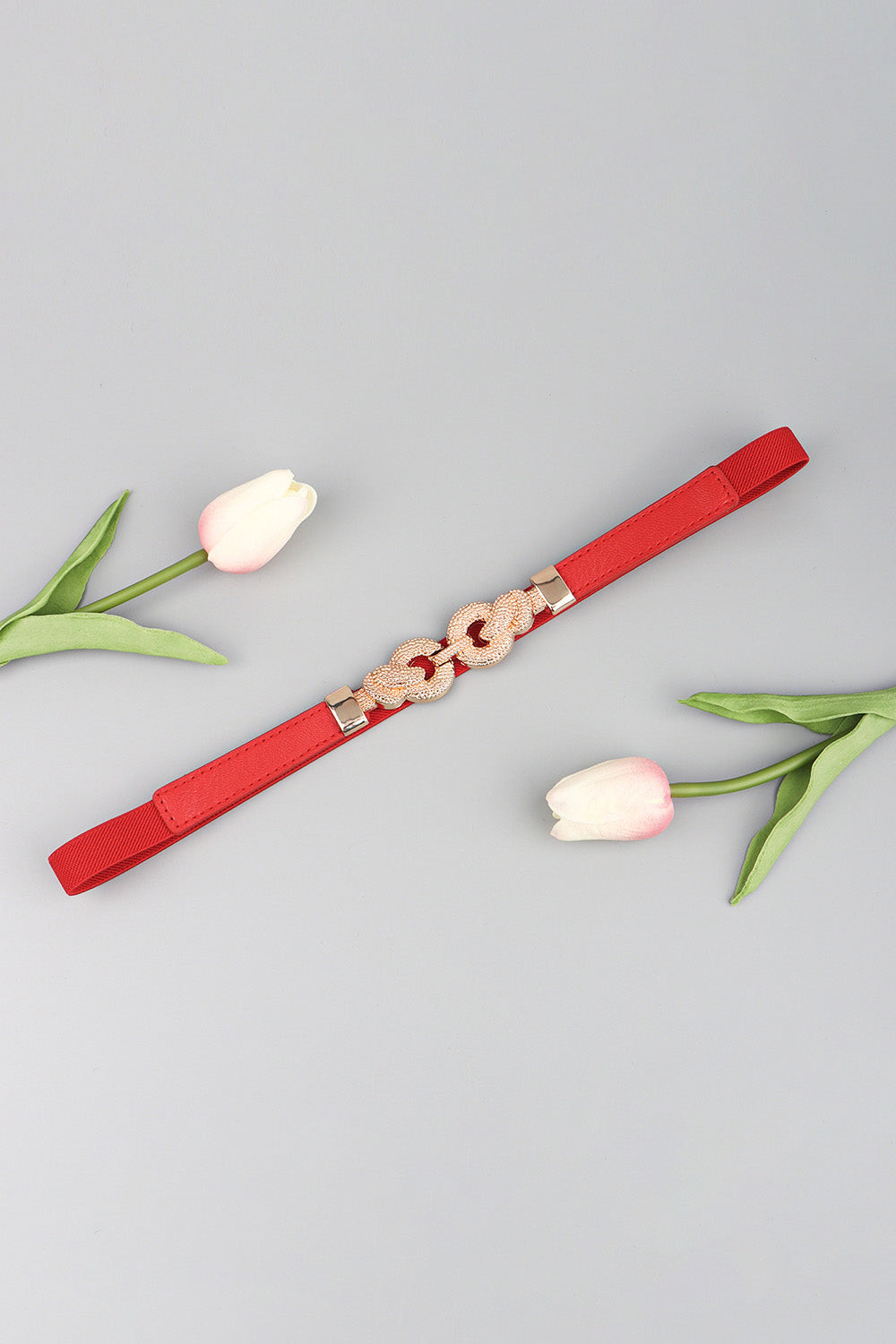 Red vegan leather belt with zinc alloy buckle and textured ring links, adjustable