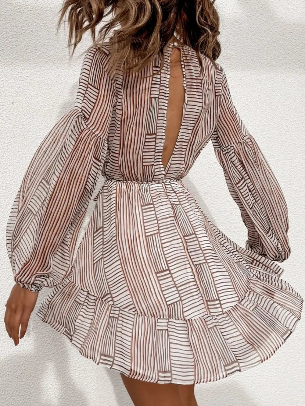 Camel-and-white striped cutout-back surplice dress with long sleeves and flared tiered hem