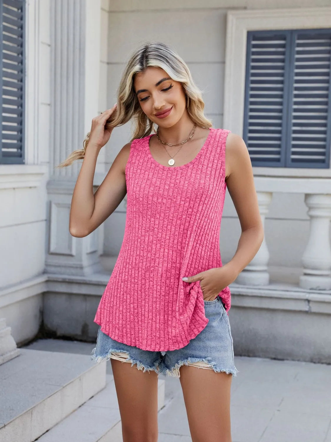 Hot pink ribbed round-neck sleeveless tank with curved hem and relaxed drape