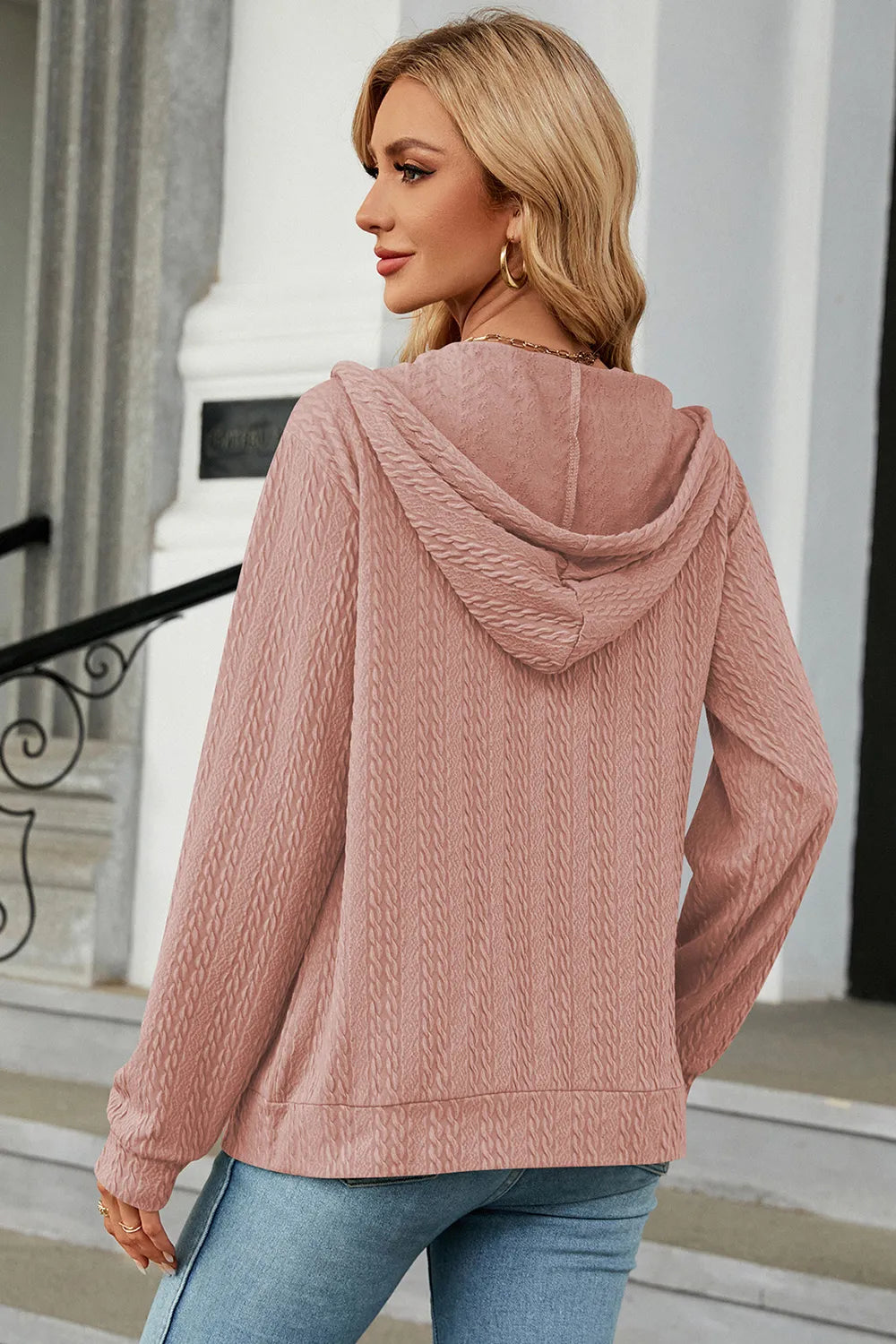 Dusty pink zip-up hoodie with drawstring hood, showing back view and long sleeves
