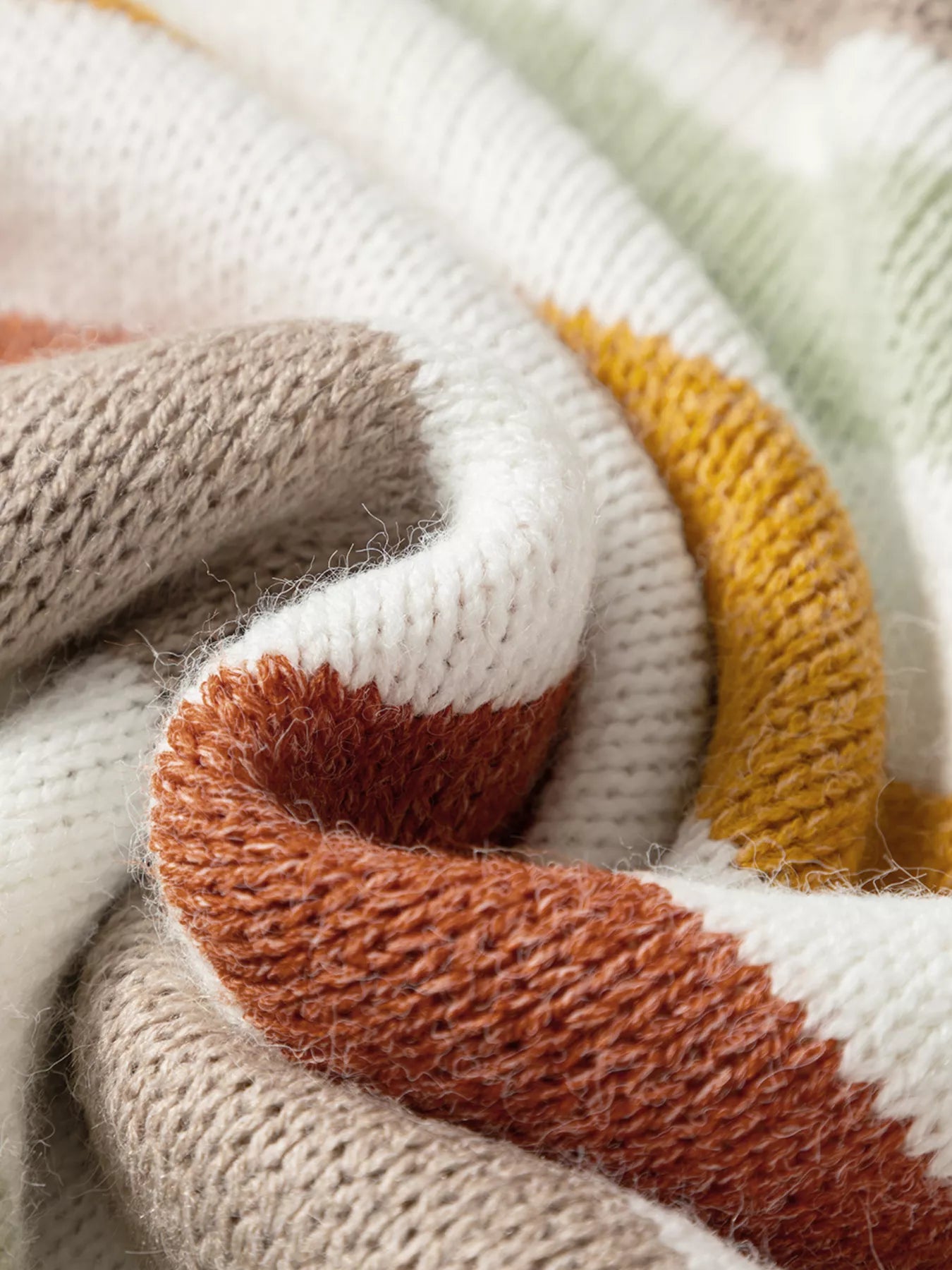 Close-up of multicolour striped knit fabric with textured weave and rib trim