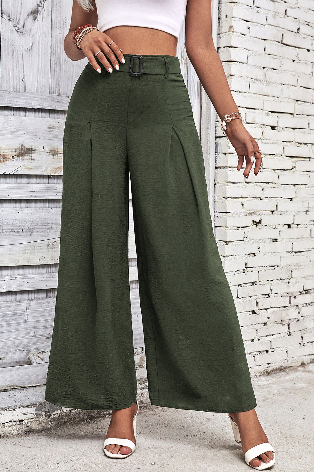 High-waisted wide-leg pants in deep green with front pleat and belt loops.