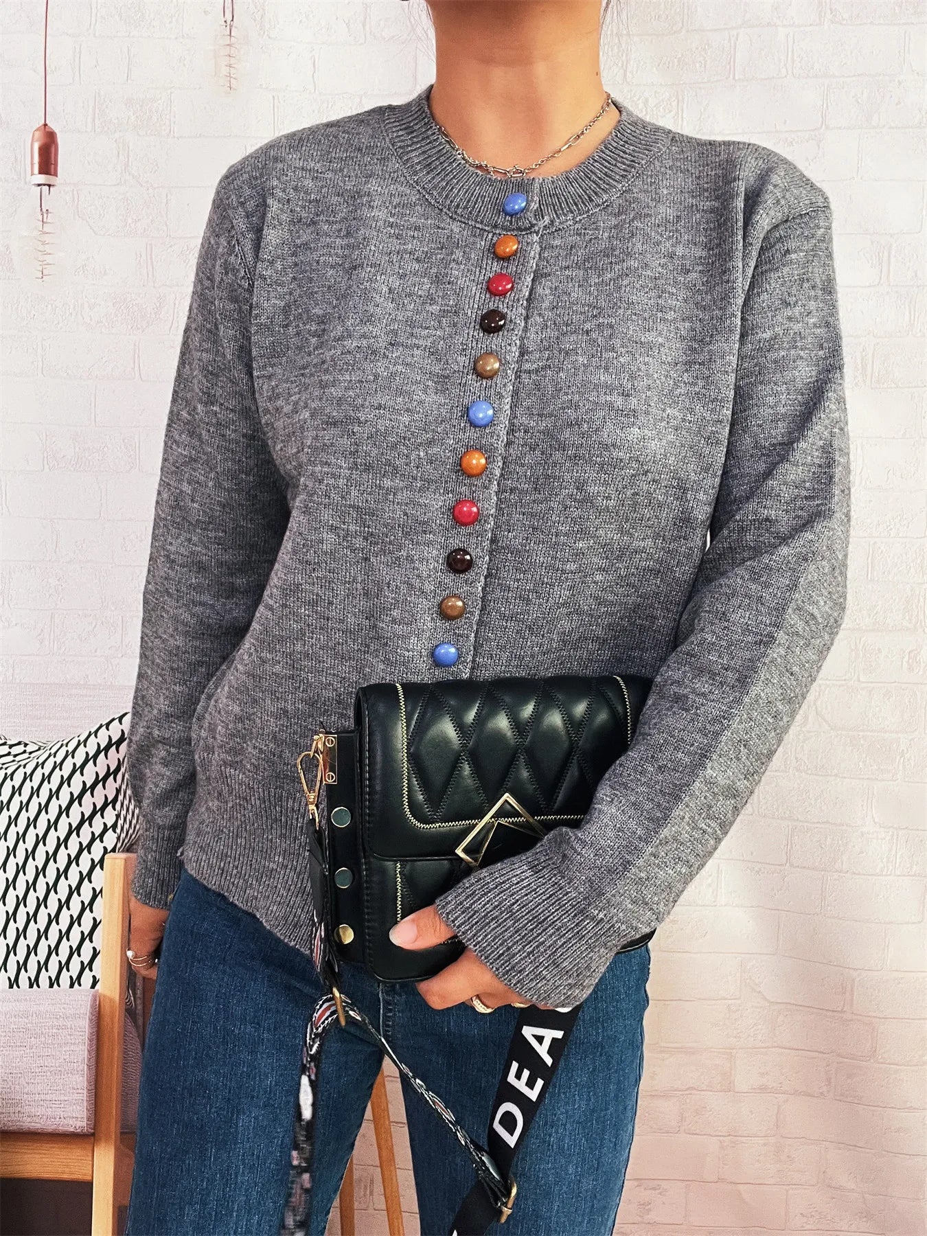 Gray button-front cardigan with long sleeves and colorful center button detail