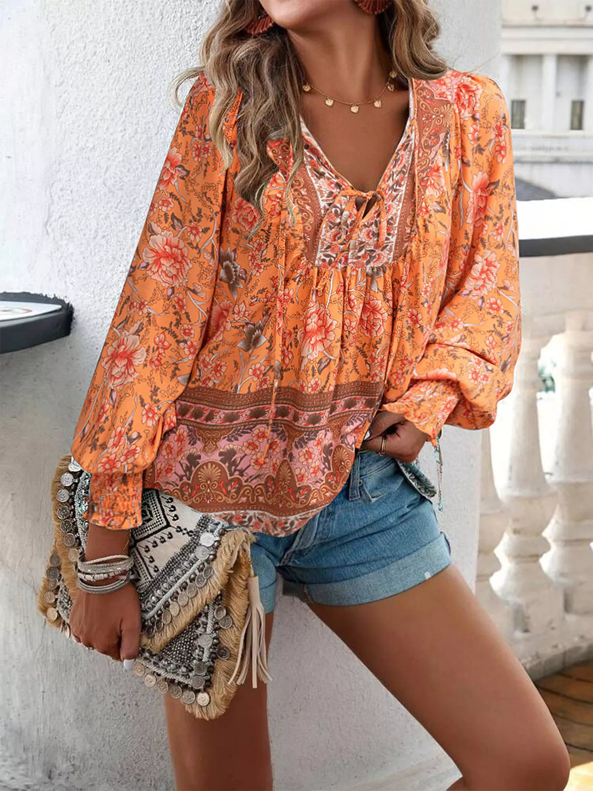 Floral tie-neck blouse with smocked cuffs in orange with ornate paisley borders