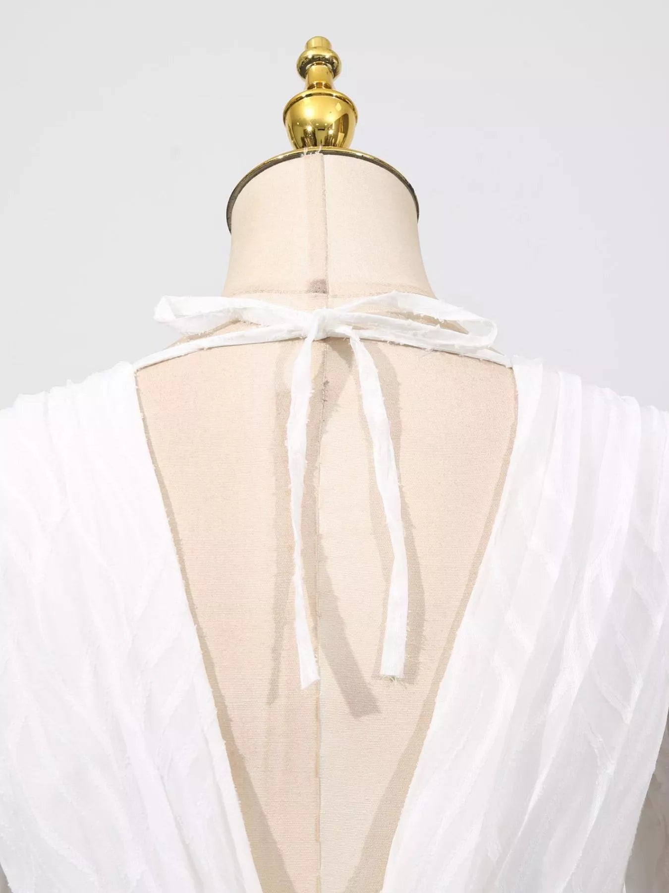 Cedar & Moore V-Neck Long Sleeve Maxi Dress on dress form; ivory fabric with back tie detail