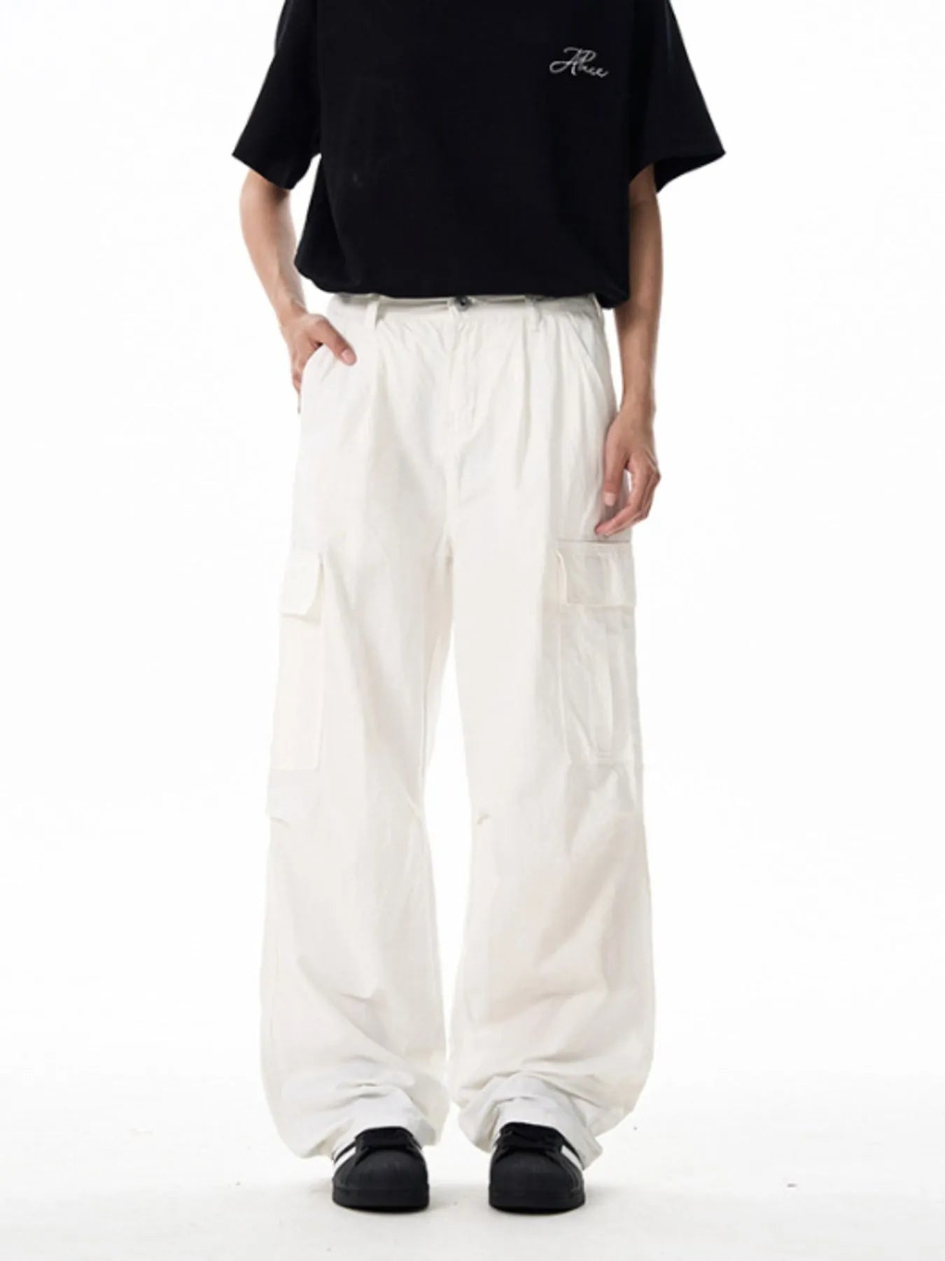 White wide-leg cargo pants with multiple cargo pockets and button waist