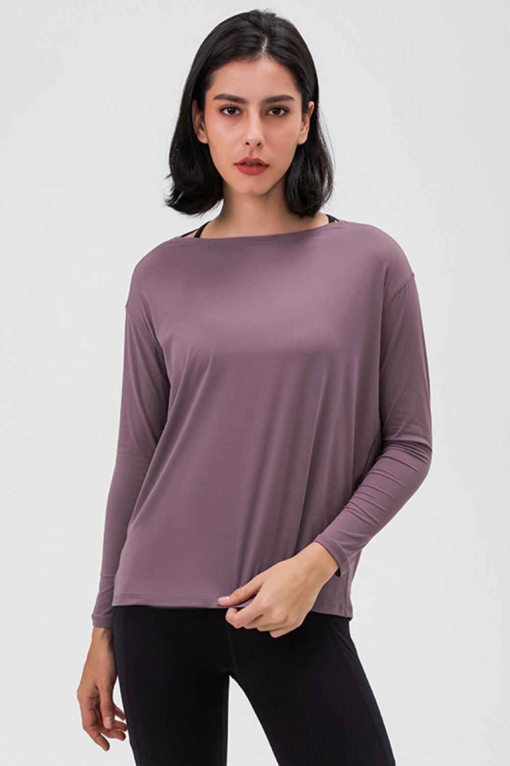 Loose-fit active top in mauve, long sleeves and relaxed drape.