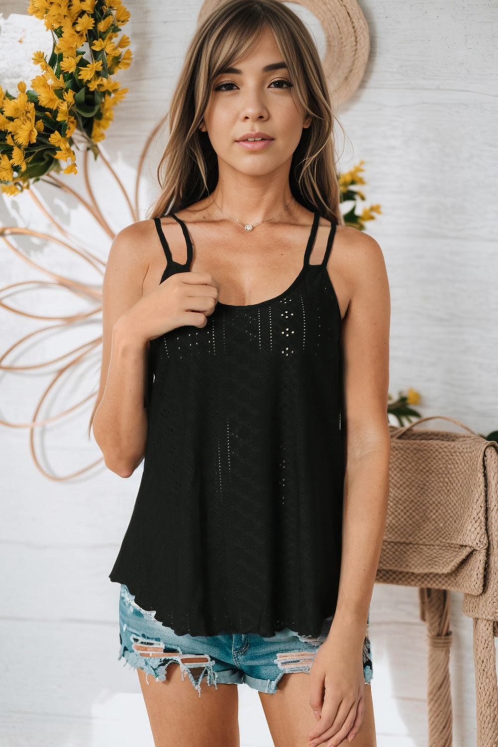 Black eyelet scoop-neck cami with thin straps and openwork dot pattern.