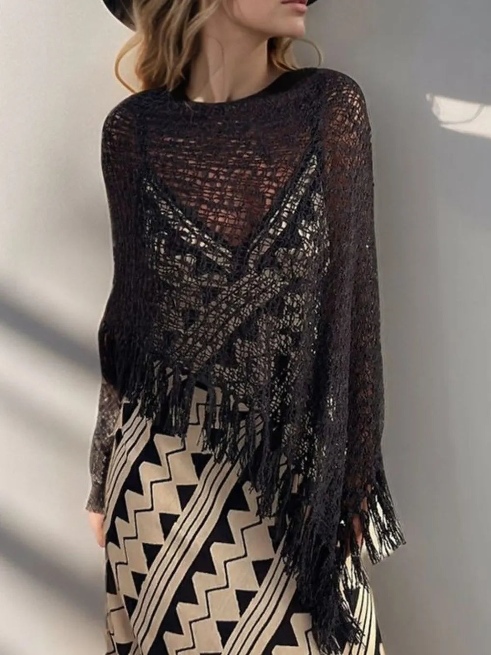 Black open-knit shawl with boat neck and long fringe tassels