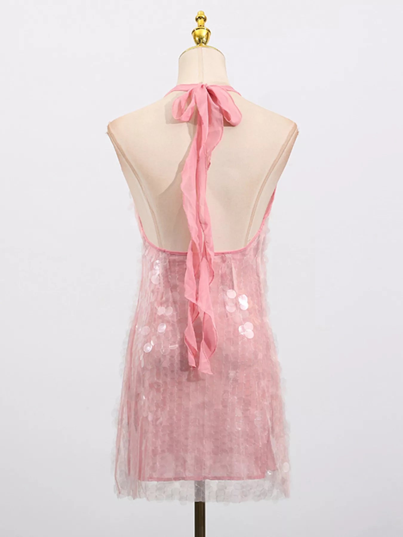 Cedar & Moore Sequin Halter Neck Mini Dress in pink, back view with tied ribbon.