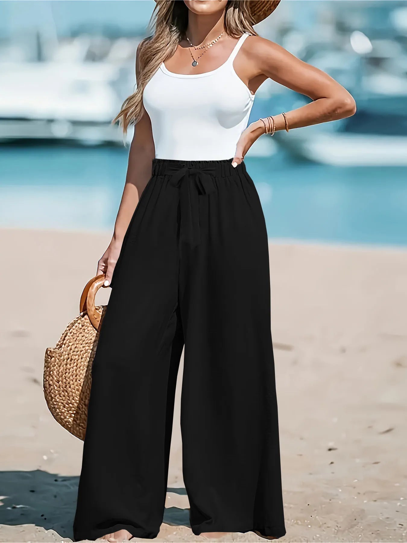 Black wide-leg drawstring pants with gathered waist, loose relaxed fit