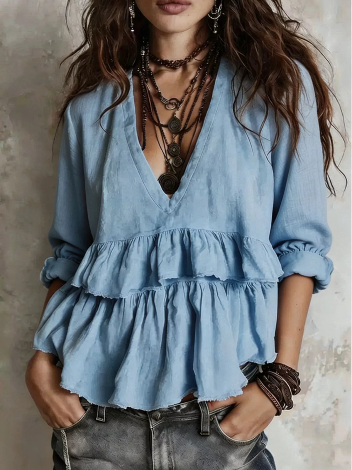 Light blue ruffled V-neck peplum blouse, long sleeves with gathered cuffs