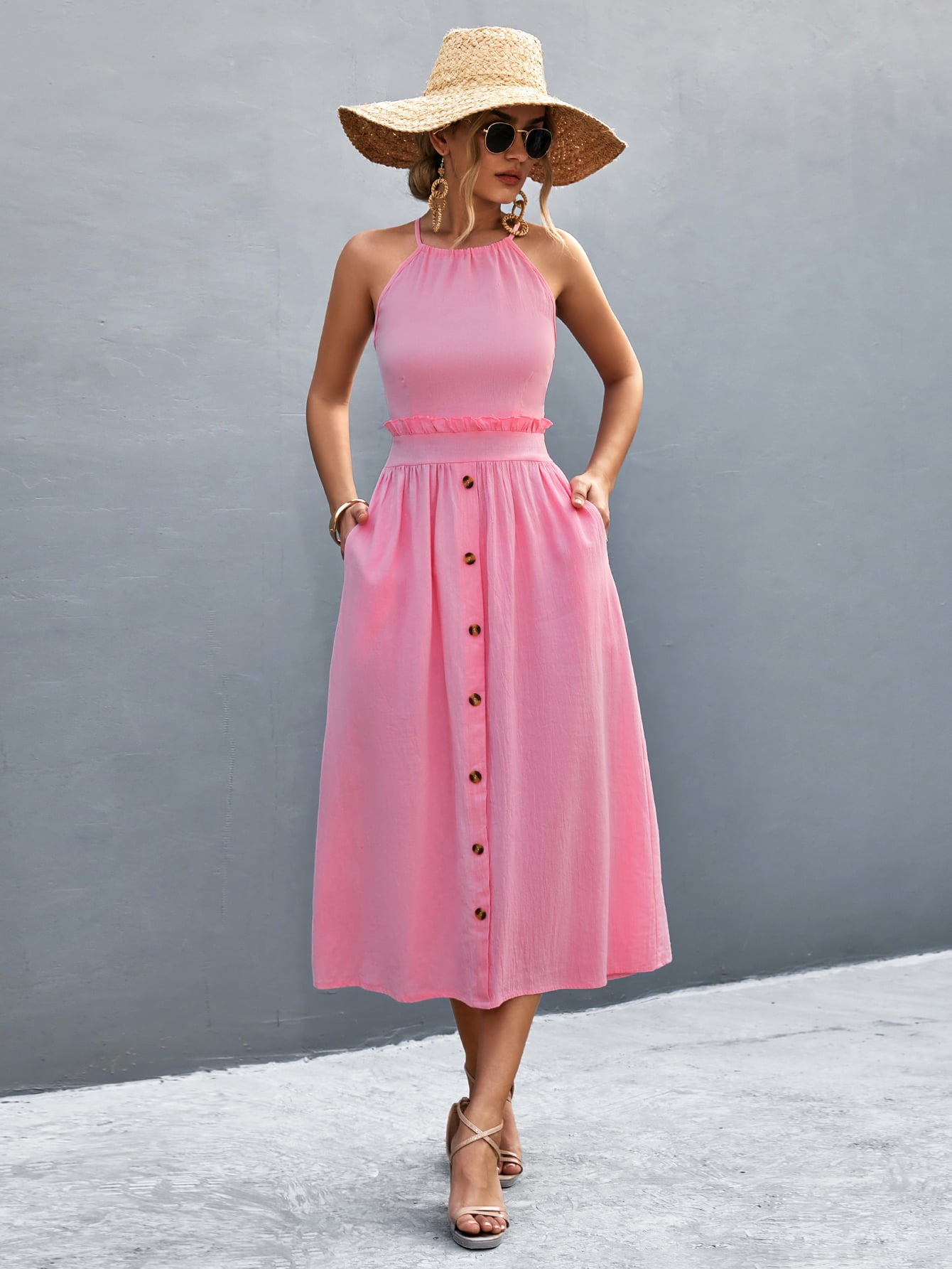 Back view: pink button-front halter neck midi dress with crisscross straps.