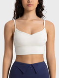 Ivory spaghetti strap sport bra with scoop neckline and smooth fitted cups