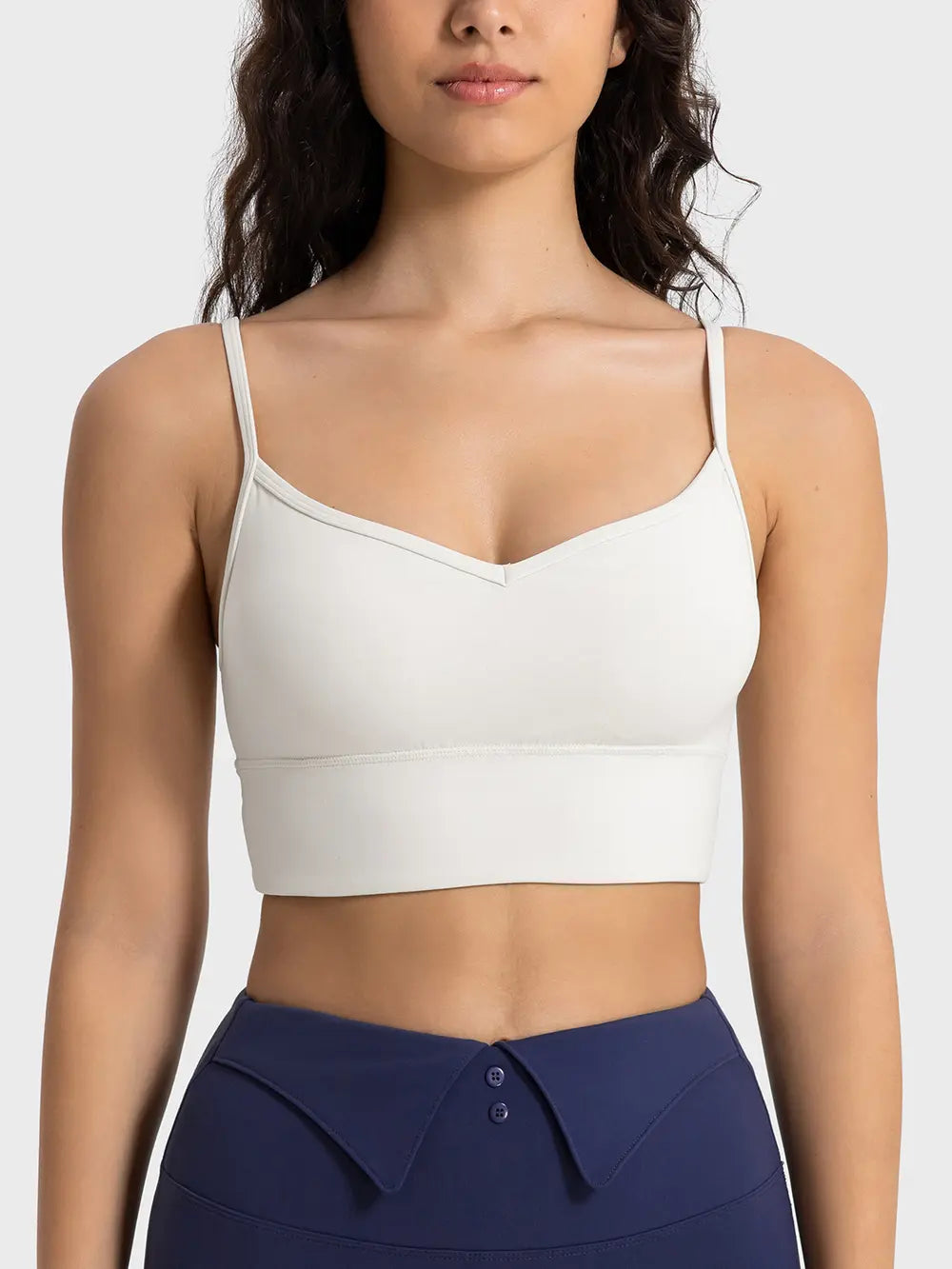 Ivory spaghetti strap sport bra with scoop neckline and smooth fitted cups