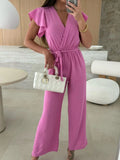 Fuchsia pink tied ruffled wide-leg jumpsuit with flutter sleeves and V-neckline