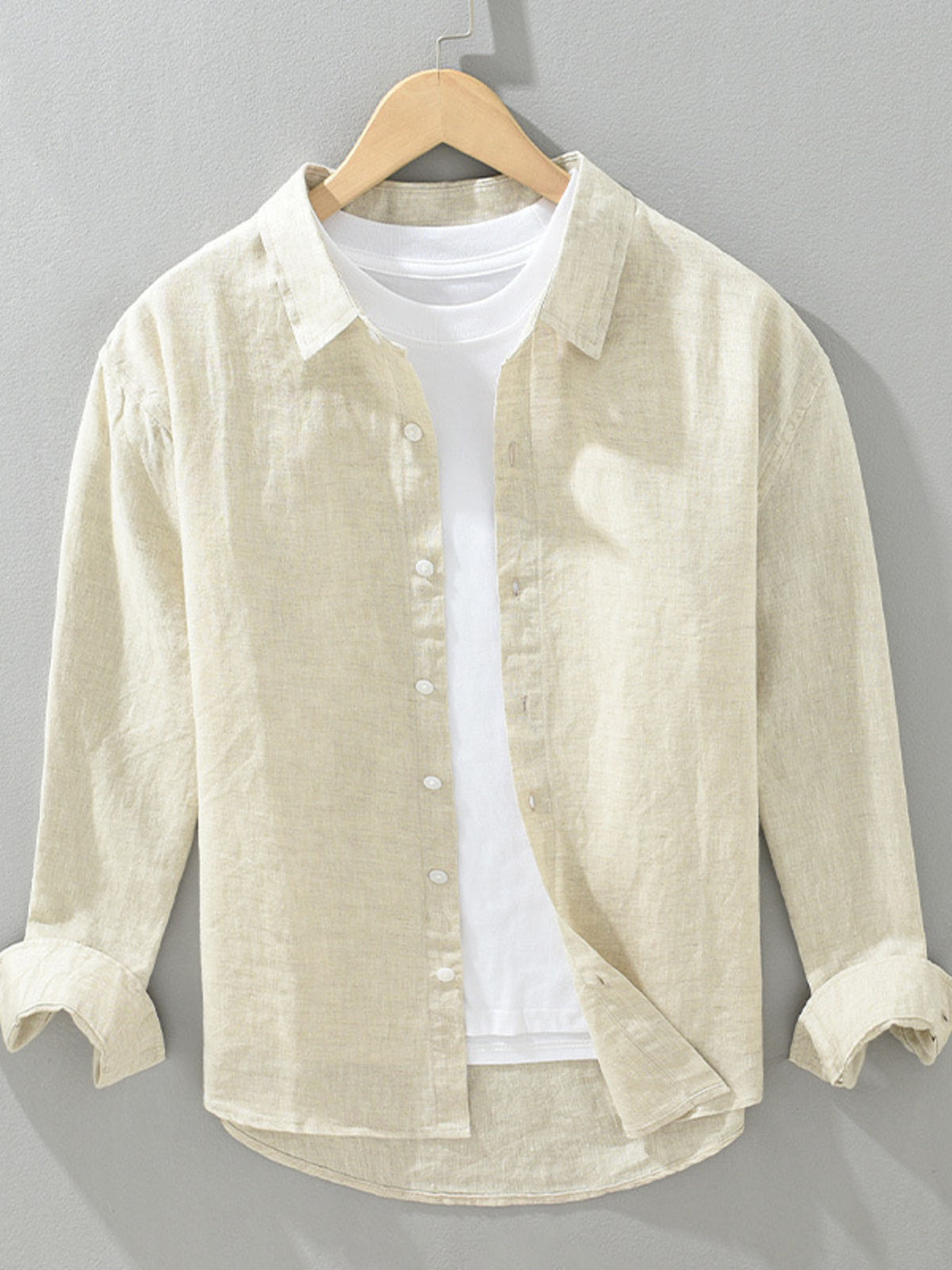 Beige cotton-blend button-up long-sleeve shirt with front buttons and pointed collar.