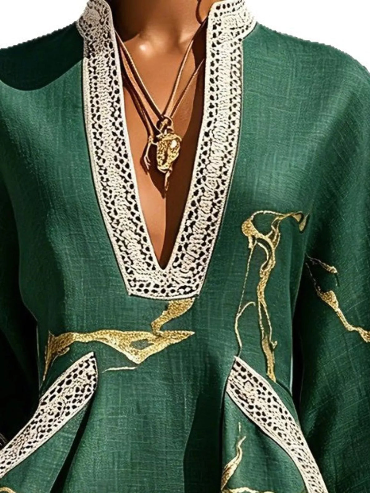Green mini dress neckline close-up with notched V lace trim and gold embroidery detail